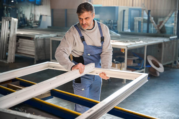 istock Proficient worker engaged in construction of PVC doors and windows 2048610278