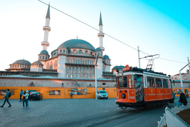 Istanbul, Turkey-February,22: The nostalgic tram in Taksim Square, Taksim Mosque, People in the Taksim Square