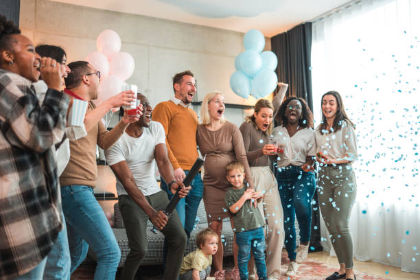 istock Diverse Group Celebrating Gender Reveal With Blue Confetti Indoors 2048619160