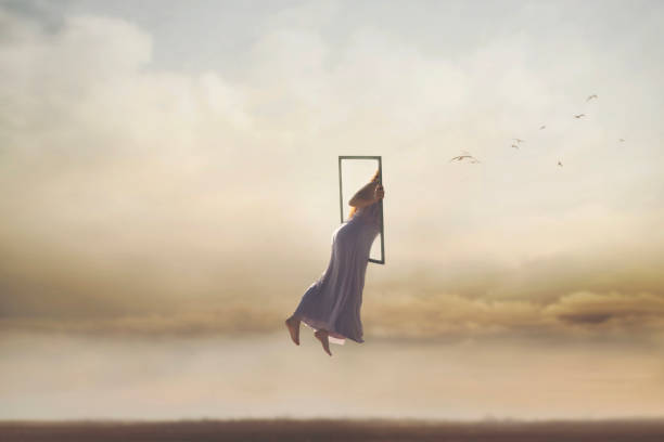 surreal and magical journey of a woman who disappears from the real world through a frame, merging into the sky, abstract concept - imagination fantasy invisible women imagens e fotografias de stock