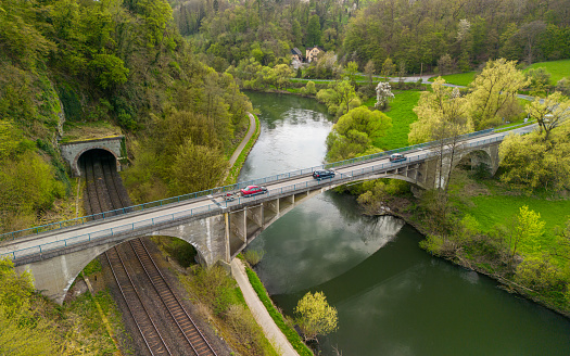 Bridge going over the train tracks and the river in weinbach, hessen, germany