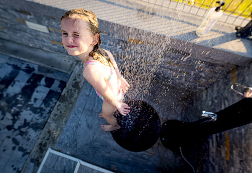 Little girl taking a shower, view from above