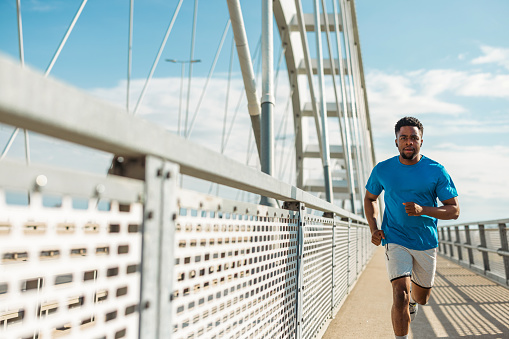 Charting new paths on his outdoor run, a young African American man redefines his fitness journey, embracing the unpredictable terrain as a metaphor for overcoming life's obstacles through strength and perseverance