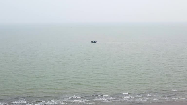 Solitary fishing trawler on the vast Indian Ocean