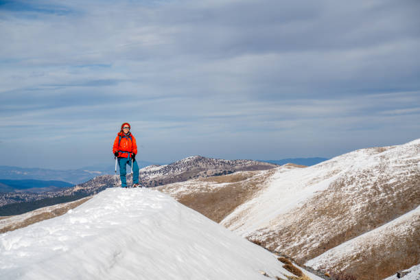 Alpinist climber is proud  and happy for being on the summit of a mountain