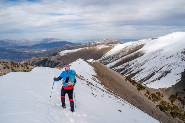 istock Mountain climber  is walking on the mountain while watching  the beautiful landscape of  mountain summit. 2048714908
