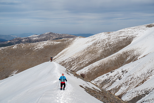 Alpinist climber  is on expedition  on the mountain,  he is returning from the summit.