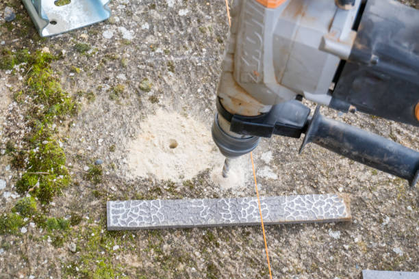 istock electrical screwdriver tightens a screw on an iron support on a wooden pillar 2048740517