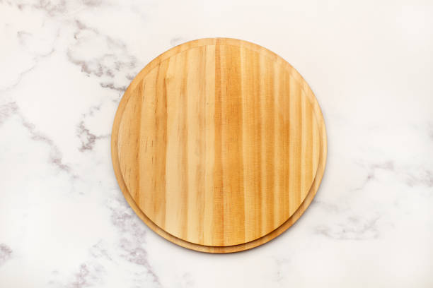 istock A wooden plate on a gray and white marble kitchen counter in a top view 2048743078