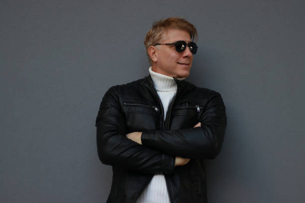 posing wall grey sunglasses leather jacket positive emotion casual