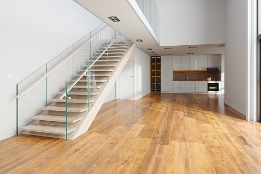 Stairs, glass banister and doors in modern hallway on the attic