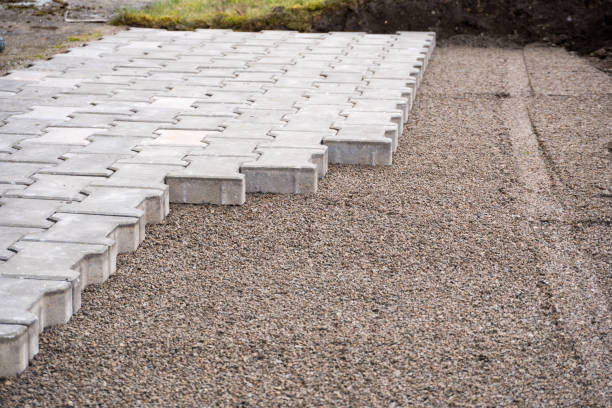 istock Laying gray concrete paving slabs in house courtyard driveway. Professional work 2048762620