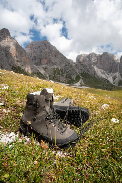 Dirty trekking boots with lake and mountain background