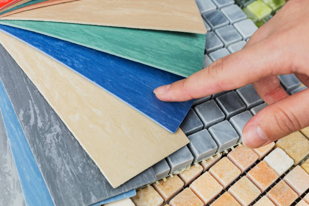 istock designer's hand choosing samples of interior stone material consists concrete tiles, quartz stones, artificial stones, graphic tile. 2048857556
