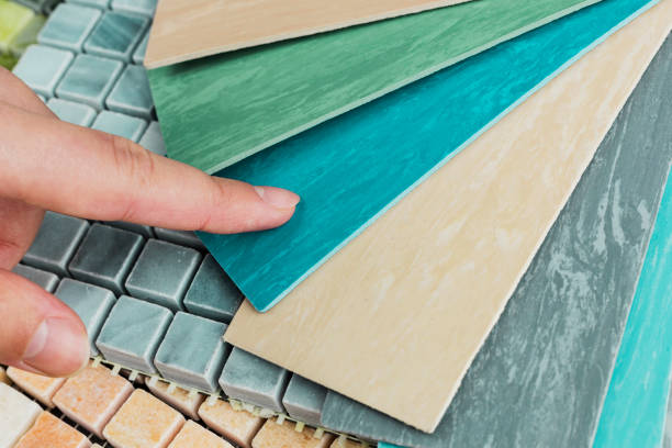 istock designer's hand choosing samples of interior stone material consists concrete tiles, quartz stones, artificial stones, graphic tile. 2048866009