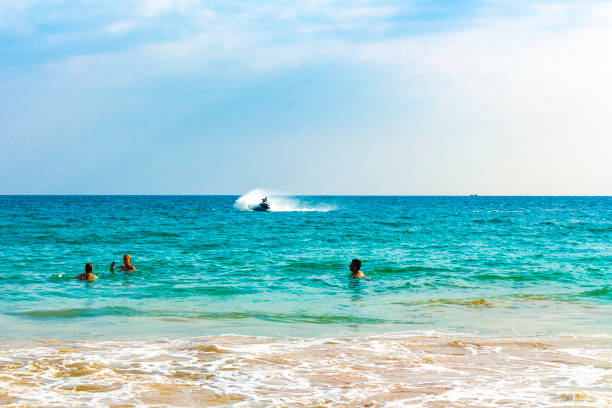 Beautiful paradise tropical beach with palm trees waves and sea water view in Mirissa Beach Southern Province Sri Lanka.
