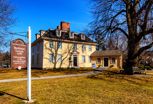 Lexington, Massachusetts, USA - February 26, 2024: Buckman Tavern is a historic American Revolutionary War site associated with the revolution's very first battle, the 1775 Battle of Lexington and Concord. It is located on the Battle Green in Lexington. The tavern was built in about 1709-1710 by Benjamin Muzzey, and with license granted in 1693 was the first public house in Lexington. Although best known as the headquarters of the militia, Buckman Tavern is also noteworthy as perhaps the busiest of Lexington's 18th-century taverns. It housed the first village store in Lexington, and later, in 1813, the first town post office.