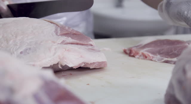 slicing pork inside the butcher shop