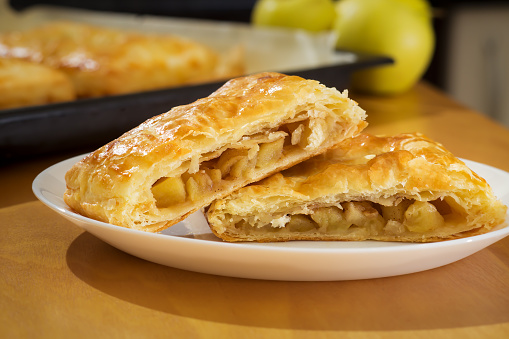 Homemade puff pastry pie filled with apple and cinnamon, healthy homemade baking concept