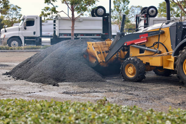 istock Heavy equipment scooping up hot asphalt 2048992237