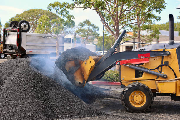 istock Heavy equipment scooping up hot asphalt 2048992248