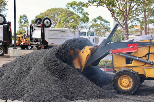 istock Heavy equipment scooping up hot asphalt 2048992251