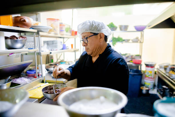 istock Professional cook working in the kitchen. Chef in action 2049049705