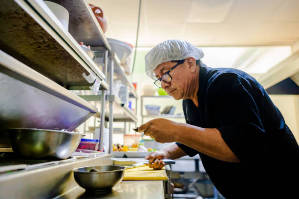 istock Professional cook working in the kitchen. Chef in action 2049049709