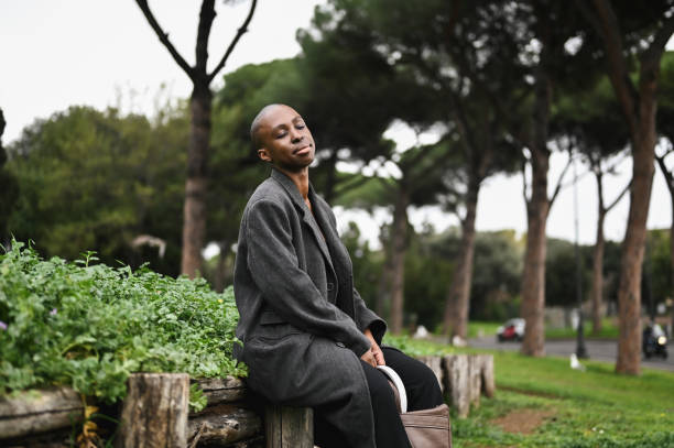 Young woman contemplating in a city parkland.