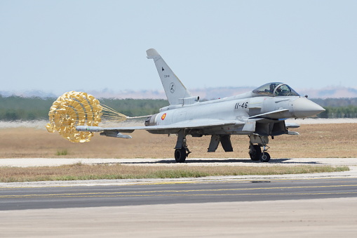 Eurofighter Typhoon fighter plane of the Spanish Air Force performing training maneuvers during a sunny day with blue sky in Andalusia, Spain. Concept: defense, war, army, air force.