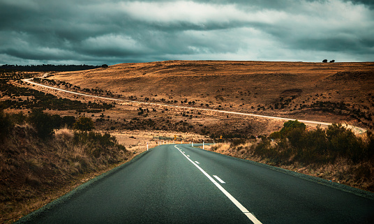 The view of the winding driveway in regional Tasmania in overcast days in autumn