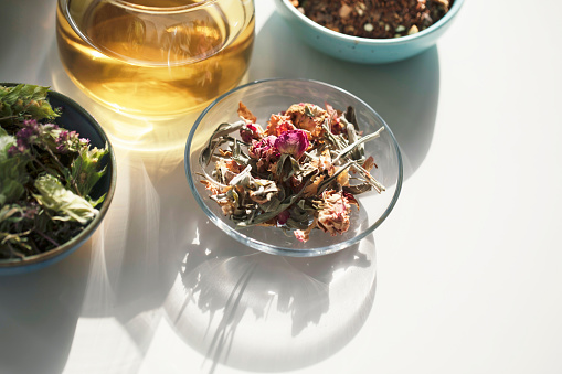 Close-up of cup tea and herbs, dry teas.