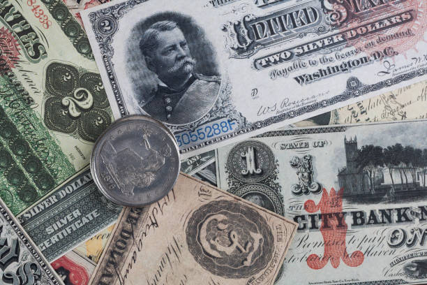 istock Old west period US banknotes and silver certificates with silver dollar coins 2049123209