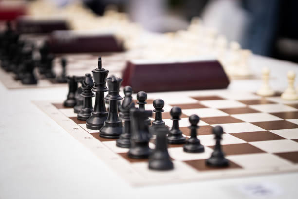 istock Simultaneous game session, a massive collective game of chess.. Chess pieces on chess board outside 2049126488
