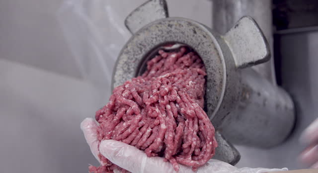 producing minced beef inside the butcher shop