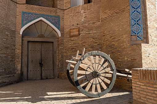 An ancient wooden  cart on the street of the ancient city of Khiva.
