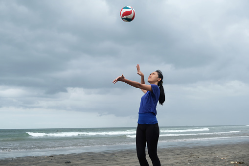 Close-up shot of Indonesian Female Volleyball Players Practicing Her Serving Skills
