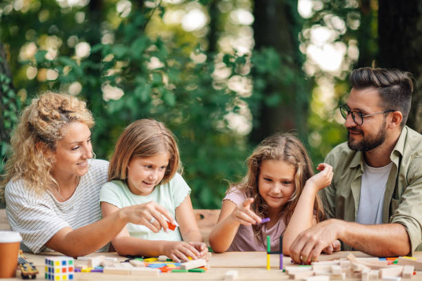 istock Playful family is spending time in nature playing a board game. 2049135848