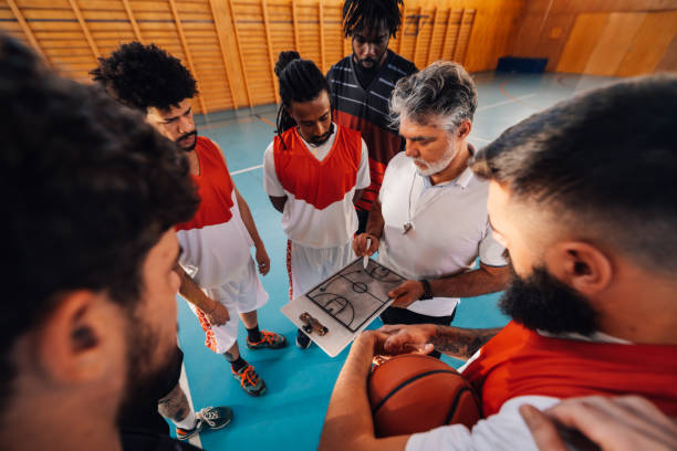 istock Basketball trainer working on game tactic with his interracial team. 2049135866