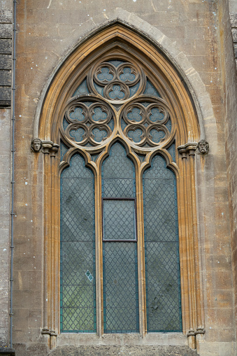Remarkable details of the Arundel Cathedral Gothic window with pointed arch. Stunning artwork on a medieval church window. Outstanding historic and religious tourist attraction in United Kingdom.