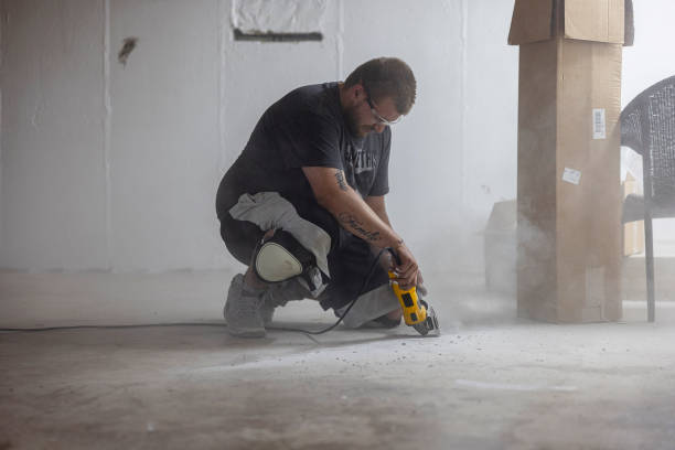 istock Shredding cracks in basement floor with angle grinder for waterproofing. 2049153508