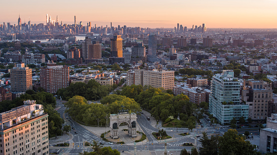 Historic Grand Army Plaza with Soldiers and Sailors Memorial Arch in Brooklyn, NY with panoramic view including Manhattan at the backdrop, at sunrise.