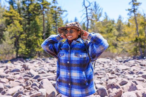 Discovering Pennsylvania's natural treasures: Hispanic tourist explores Boulder Field - Ice Age geological formation in Hickory Run State Park, Poconos region, Pennsylvania