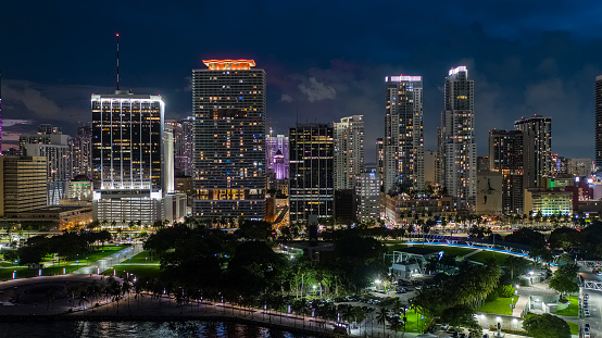 Illuminated Downtown skyscrapers rise above Miami, FL cityscape at night