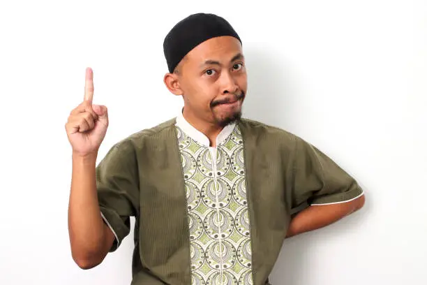 Photo of Indonesian Muslim man has an idea on a White background