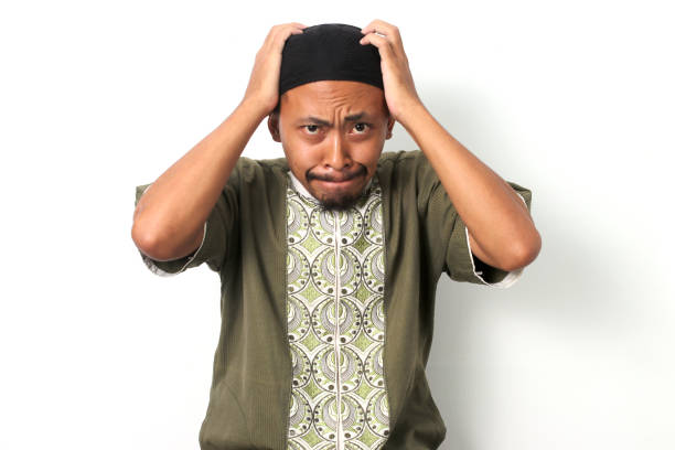 istock Anxious Indonesian Muslim Man Expresses Failure and Frustration 2049177227