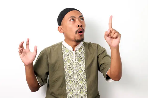 Photo of Indonesian Muslim man has an idea on a White background