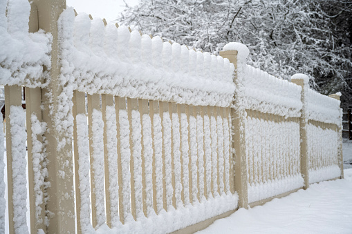 Fence covered with snow