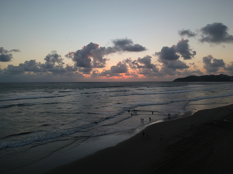 View of beach with a body of water at sunset