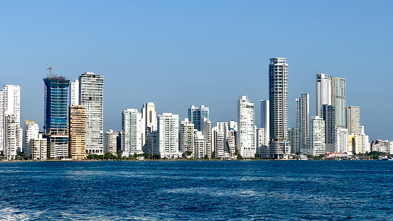 Modern buildings in city against clear blue sky